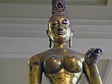 British Museum Top 20 06 Gilded Bronze Tara 6. Standing Tara � Sri Lanka, 8C AD, 143cm high. The statue of Tara, the consort of Avalokiteshvara, is solid cast in one piece of bronze and gilded. The goddess is naked to the waist with a lower garment flowing to her ankles. The marked contrast of the slender waist against heavy breasts and hips is the ideal of feminine beauty. Tara's right hand is shown in the mudra of giving; her left hand is empty but may have held a lotus flower.